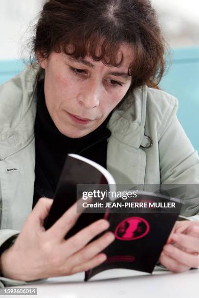 La présidente du mouvement "Ni putes, ni soumises", Fadela Amara consulte, le 30 mars 2005 à Paris, un "guide du respect", petit livre soulevant les...