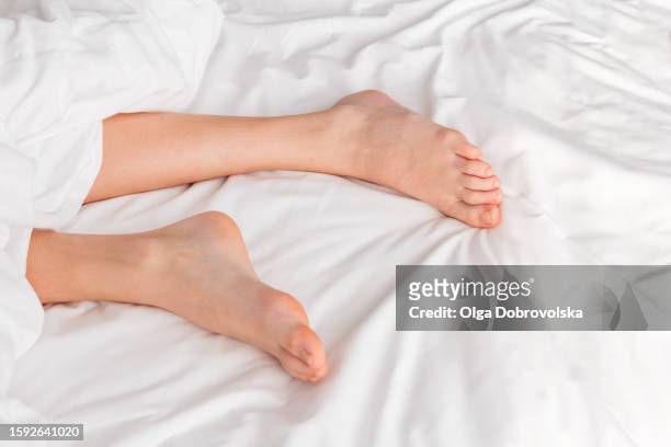 bare feet of a boy sleeping on a bed, elevated view - tween heels stock pictures, royalty-free photos & images