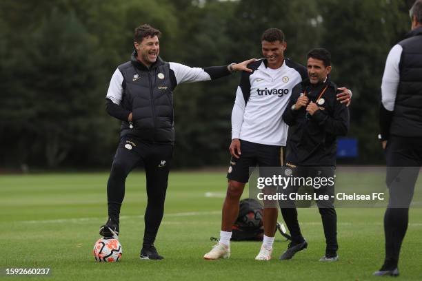 Head Coach, Mauricio Pochettino and Assistant Head Coach, Jesus Perez joke with Thiago Silva during the training session at Chelsea Training Ground...