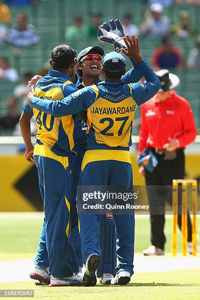 Ajantha Mendis of Sri Lanka is congratulated by team-mates after getting the wicket of Aaron Finch of Australia during game one of the Commonwealth...