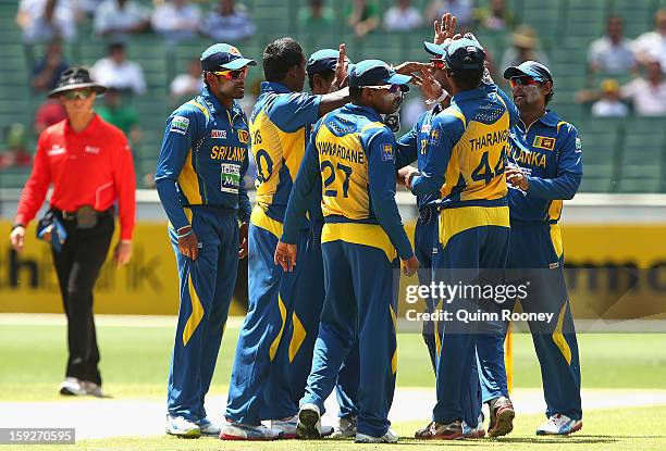 Ajantha Mendis of Sri Lanka is congratulated by team-mates after getting the wicket of Aaron Finch of Australia during game one of the Commonwealth...
