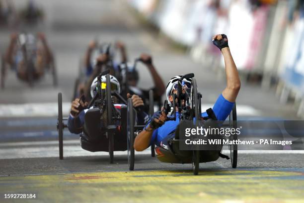 Italy's Mirko Testa celebrates winning the Men H3 Road Race with France's Johan Quaile second on day nine of the 2023 UCI Cycling World Championships...