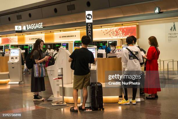 Traavelers use termninals to check in at the domestic depature terminal of Haneda airport, , in Tokyo, Japan, 11 Aug 2023.