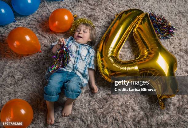 a laughing child of 4 years old plays at childrens birthday party with balloon - 4 5 years balloon stock pictures, royalty-free photos & images