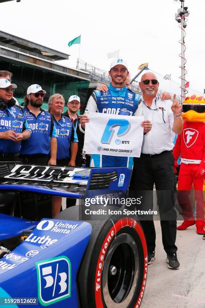 Graham Rahal poses with his dad and team owner Bobby Rahal after winning the pole during qualifications for the NTT INDYCAR Series Gallagher Grand...