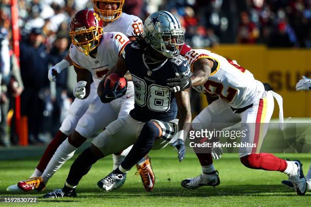 CeeDee Lamb of the Dallas Cowboys carries the ball during an NFL game against the Washington Football Team at FedEx Field on December 12, 2021 in...