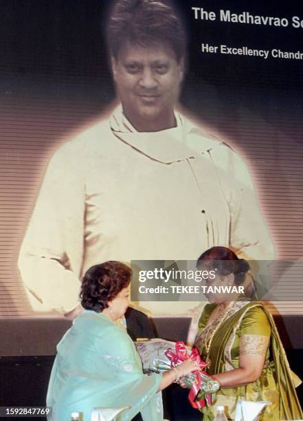 The wife of late Congress Party leader Madhav Rao Scindia, Madhavi Raje Scindia , presents a bouquet of lowers to Sri Lanka President Chandrika...