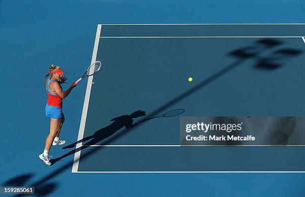 Timea Babos of Hungary plays a forehand partnering Mandy Minella of Luxembourg in their doubles semi final match against Lara Arruabarrena-Vecino and...