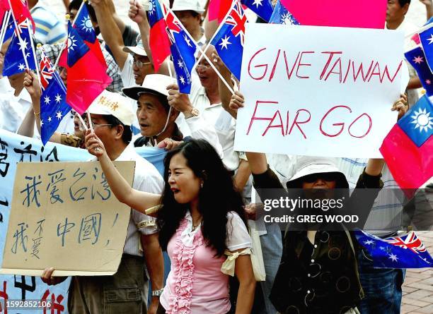 Pro-independent Taiwan activists demonstrate outside the 2002 World Congress on the Peaceful Reunification of China and World Peace in Sydney, 23...