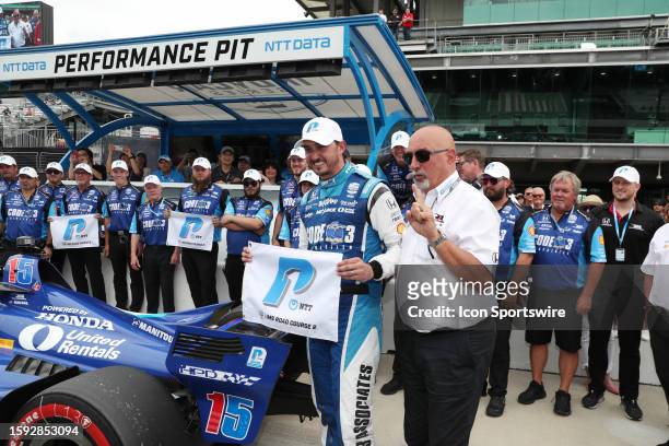 IndyCar driver Graham Rahal poses for a photo with his father and car owner Bobby Rahal after winning the pole award for the Gallager Grand Prix on...