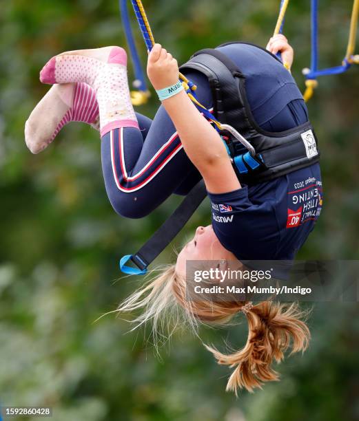 Mia Tindall plays on a bungee trampoline as she attends day 1 of the 2023 Festival of British Eventing at Gatcombe Park on August 4, 2023 in Stroud,...