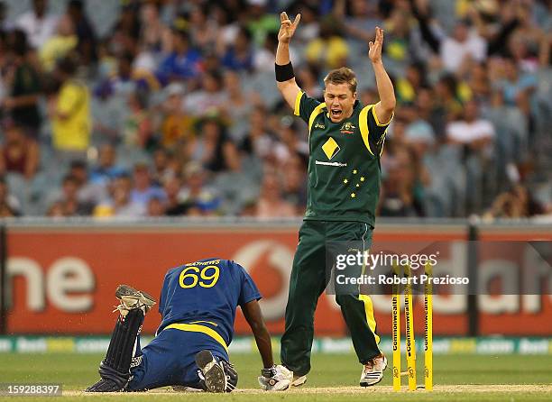 Xavier Doherty of Australia celebrates as Angelo Mathews of Sri Lanka is run out by Glenn Maxwell of Australia during game one of the Commonwealth...