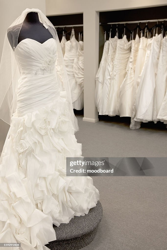 Elegant wedding dress displayed on mannequin in bridal store