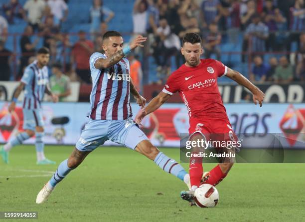 Kourbelis of Trabzonspor in action against Erdal Rakip of Bitexen Antalyaspor during the Trendyol Super Lig week 1 match between Trabzonspor and...