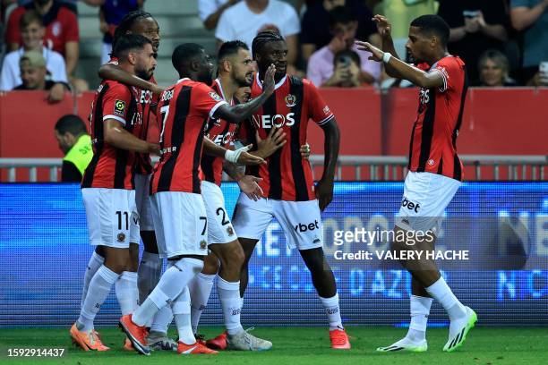 Nice's French forward Gaetan Laborde celebrates with teammates after scoring his team's first goal during the French L1 football match between Nice...