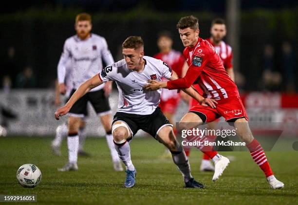 Louth , Ireland - 11 August 2023; John Martin of Dundalk in action against Fabrice Hartmann of Sligo Rovers during the SSE Airtricity Men's Premier...