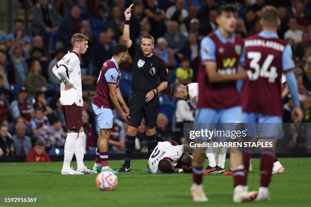 Burnley's Belgian striker Anass Zaroury reacts after receiving a yellow card following a foul he committed on Manchester City's English defender Kyle...