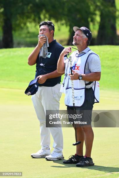 Byeong Hun An of South Korea and his caddie Justin York at the ninth hole during the second round of the FedEx St. Jude Championship at TPC Southwind...