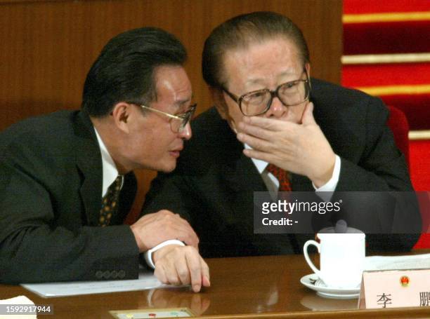 Chinese President Jiang Zemin listens to China's new number two leader and NPC Chairman Wu Bangguo during a session of the National People's Congress...
