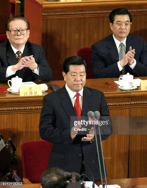 Chinese President Jiang Zemin and his successor Vice President Hu Jintao clap hands as the new Chairman of the Chinese People's Political...