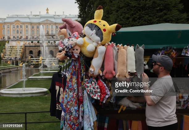 Seller install toys in a souvenir shop in front of the Peterhof Grand Palace on August 11, 2023 in Saint Petersburg, Russia. In the first half of...