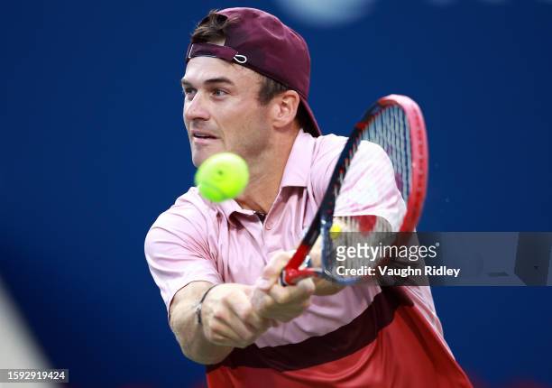Tommy Paul of the United States hits a shot against Carlos Alcaraz of Spain during Day Five of the National Bank Open, part of the Hologic ATP Tour,...