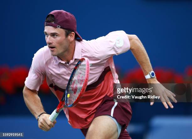 Tommy Paul of the United States charges the net against Carlos Alcaraz of Spain during Day Five of the National Bank Open, part of the Hologic ATP...