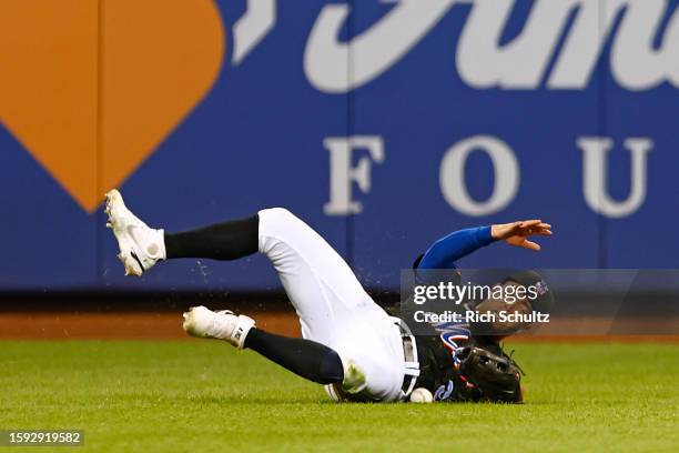Rafael Ortega of the New York Mets dives over the ball hit by Matt Olson of the Atlanta Braves during the fourth inning at Citi Field on August 11,...