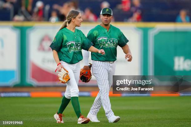 Nick Swisher and Lauren Burke of the Bouncing Pickles exit the field during the HRDX Hartford at Dunkin Park on Friday, August 11, 2023 in Hartford,...