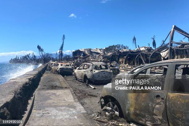 Burned cars and destroyed buildings are pictured in the aftermath of a wildfire in Lahaina, western Maui, Hawaii on August 11, 2023. A wildfire that...