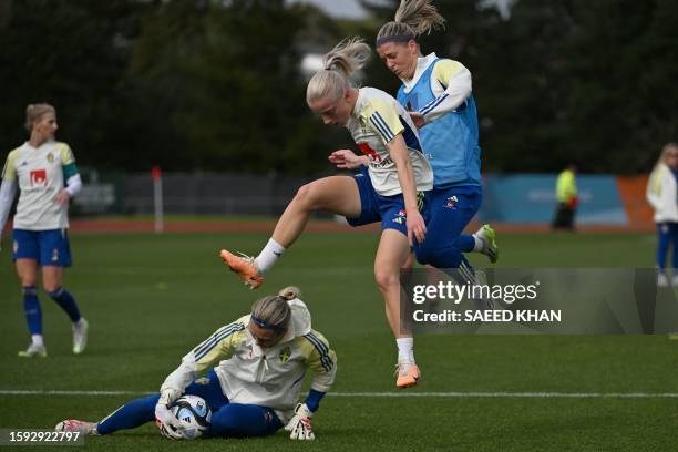 Sweden's defender Anna Sandberg and goalkeeper Jennifer Falk attend a training session in Auckland on August 12 ahead of Australia and New Zealand...