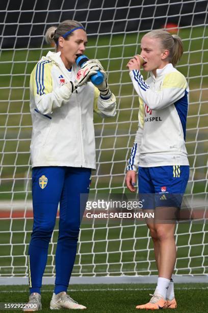 Sweden's defender Anna Sandberg and goalkeeper Jennifer Falk attend a training session in Auckland on August 12 ahead of Australia and New Zealand...