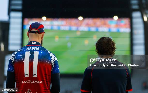 Max Gawn and Tom Sparrow of the Demons are seen watching the Matildas FIFA Women's World Cup quarter final match against France on the big screens...