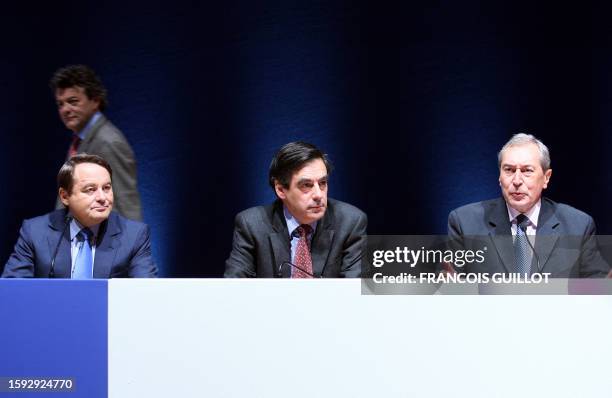 French Prime minister Francois Fillon and European deputy Andre Laignel listen to Jacques Pelissard , president of the France's mayors Association ,...