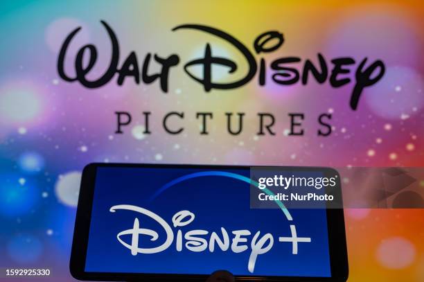 Disney + streaming icon displayed on smartphone with Walt Disney seen in the background. On 12 August 2023 in Brussels, Belgium.