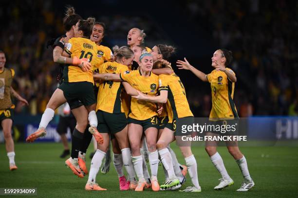 Australian players celebrate their win at the end of the Australia and New Zealand 2023 Women's World Cup quarter-final football match between...