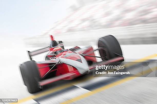 indy race car driver crossing finish line. - racewagen stockfoto's en -beelden