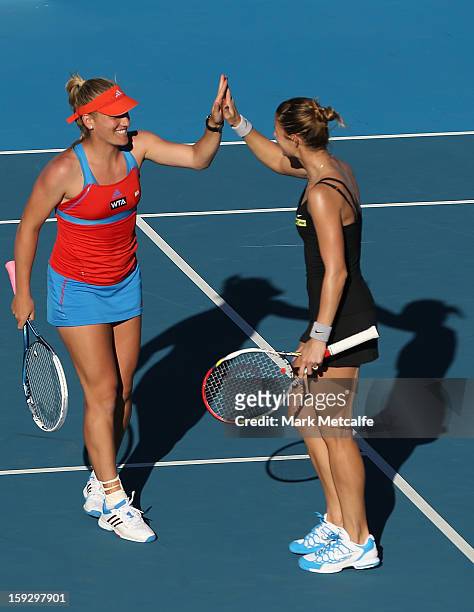 Timea Babos of Hungary and Mandy Minella of Luxembourg celebrate winning match point in their doubles semi final match against Lara...