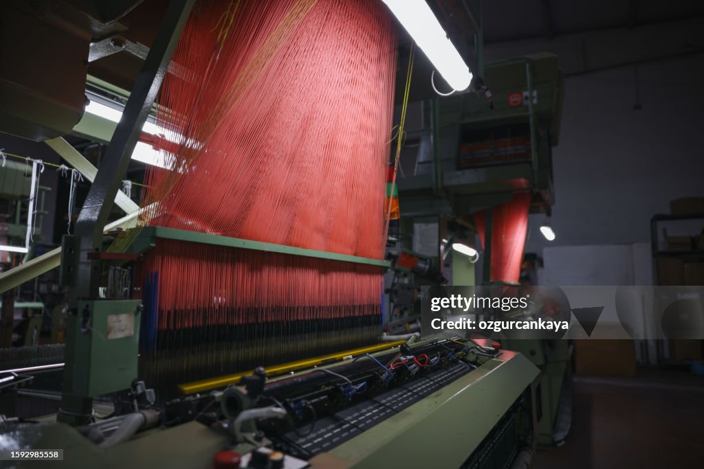Colorful Threads on a loom in weaving loom machine in textile factory