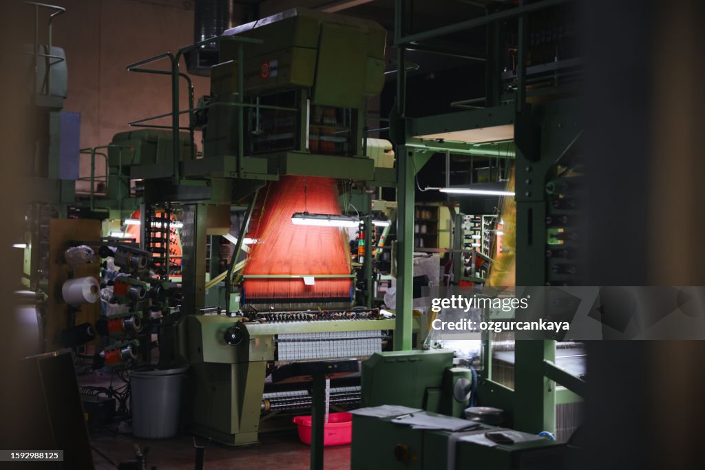 Colorful Threads on a loom in weaving loom machine in textile factory