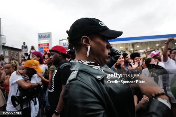 People gather at a memorial for O’Shae Sibley on August 04, 2023 in New York City. The memorial was held at the gas station where he was murdered...