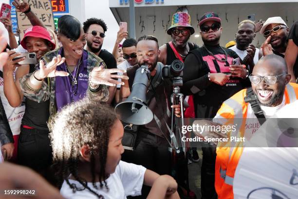 People gather at a memorial for O’Shae Sibley on August 04, 2023 in New York City. The memorial was held at the gas station where he was murdered...