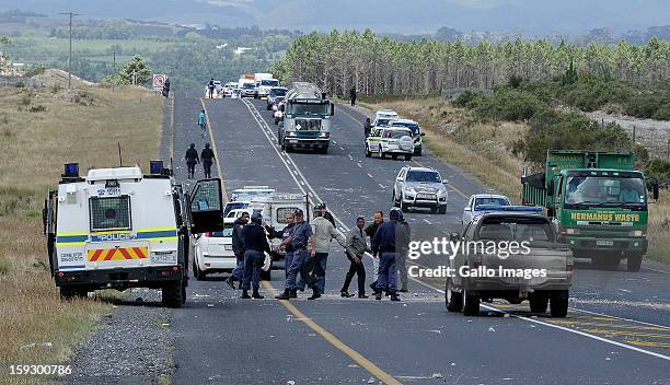 Members control traffic and assist motorists on the N2 highway on January 10, 2013 in Grabouw, South Aifrca. Striking farm workers have blocked the...