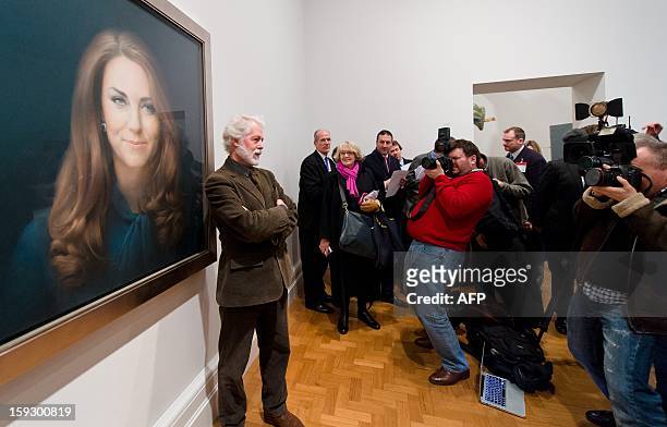 British artist Paul Emsley poses in front of his portrait of Catherine, The Duchess of Cambridge after its unveiling at the National Portrait Gallery...