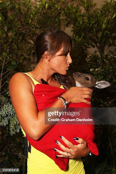 Arina Rodionova poses with a joey as she arrives at the official Australian Open player party at the Grand Hyatt on January 11, 2013 in Melbourne,...