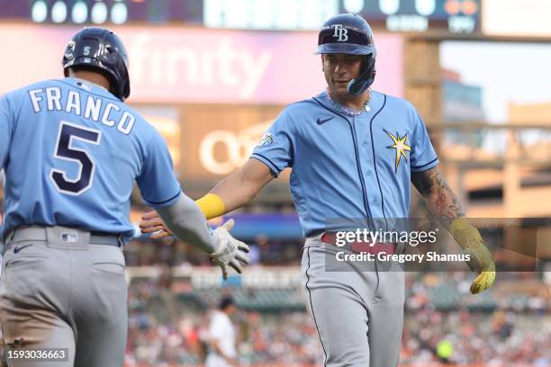 Harold Ramirez of the Tampa Bay Rays celebrates scoring a sixth inning run with Wander Franco while playing the Detroit Tigers at Comerica Park on...