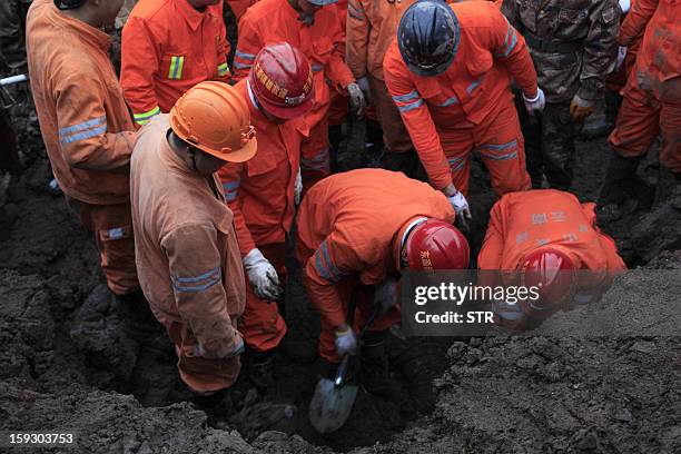 Chinese rescue workers search for buried residents in a disaster-hit area in Gaopo village, southwest China's Yunnan province on January 11, 2013. A...