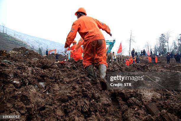 Chinese rescue workers search for buried residents in a disaster-hit area in Gaopo village, southwest China's Yunnan province on January 11, 2013. A...
