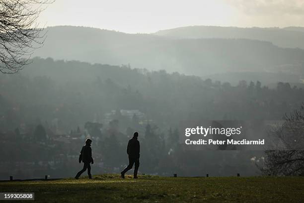 Walkers take in the view from the lookout point on Box Hill on January 11, 2013 near Dorking, England. After a mild spell the United Kingdom is...