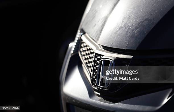 The Honda logo is seen on a worker's Honda Civic parked in the car park at the Honda car assembly plant following the announcement that the firm is...